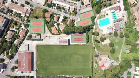 Sports-activity-park-football-field-tennis-courts-swimming-pool-aerial-top-shot